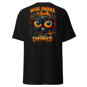 Back view of a black T-Shirt featuring a wide-eyed orange owl beneath “Wide Awake, Slightly Unhinged” lettering