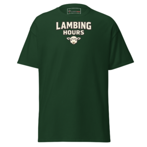 Front view of a forest-green T-Shirt featuring cream “Lambing Hours” lettering above a small sheep-face illustration