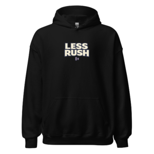 Back view of a black Hoodie featuring bold cream “Less Rush” lettering with two small pause-style bars beneath