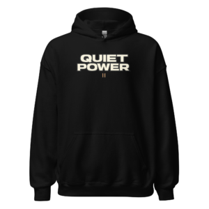 Back view of a black Hoodie featuring bold cream “Quiet Power” lettering with two short vertical marks beneath
