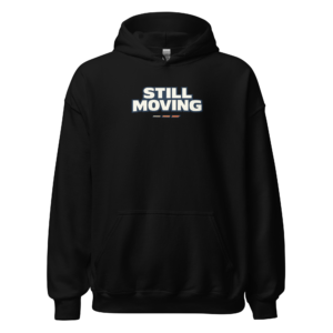 Back view of a black Hoodie featuring bold cream “Still Moving” lettering with three short blue motion lines beneath