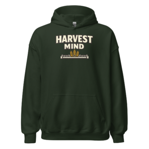 Front view of a forest-green Hoodie featuring cream “Harvest Mind” lettering above a small wheat-and-machine line graphic