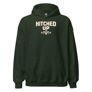 Front view of a forest-green Hoodie featuring cream “Hitched Up” lettering above a small tractor-and-implement coupling graphic