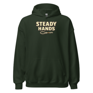Front view of a forest-green Hoodie featuring cream “Steady Hands” lettering above a small linked-hand or chain emblem